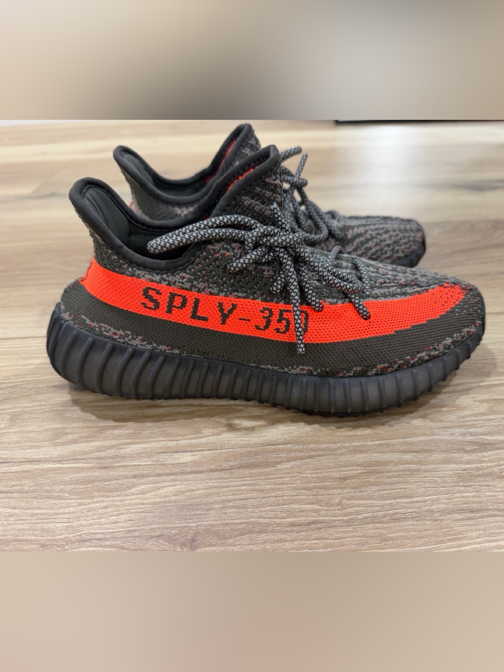 Yeezy Boost-style Black Knit Sneakers with Bright Orange Stripe